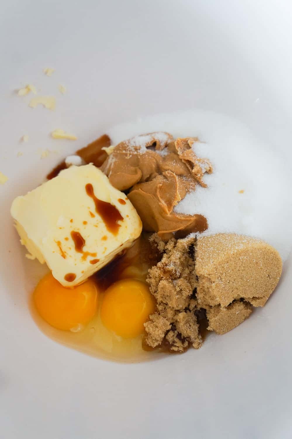 butter, peanut butter, eggs, brown sugar and white sugar in a mixing bowl