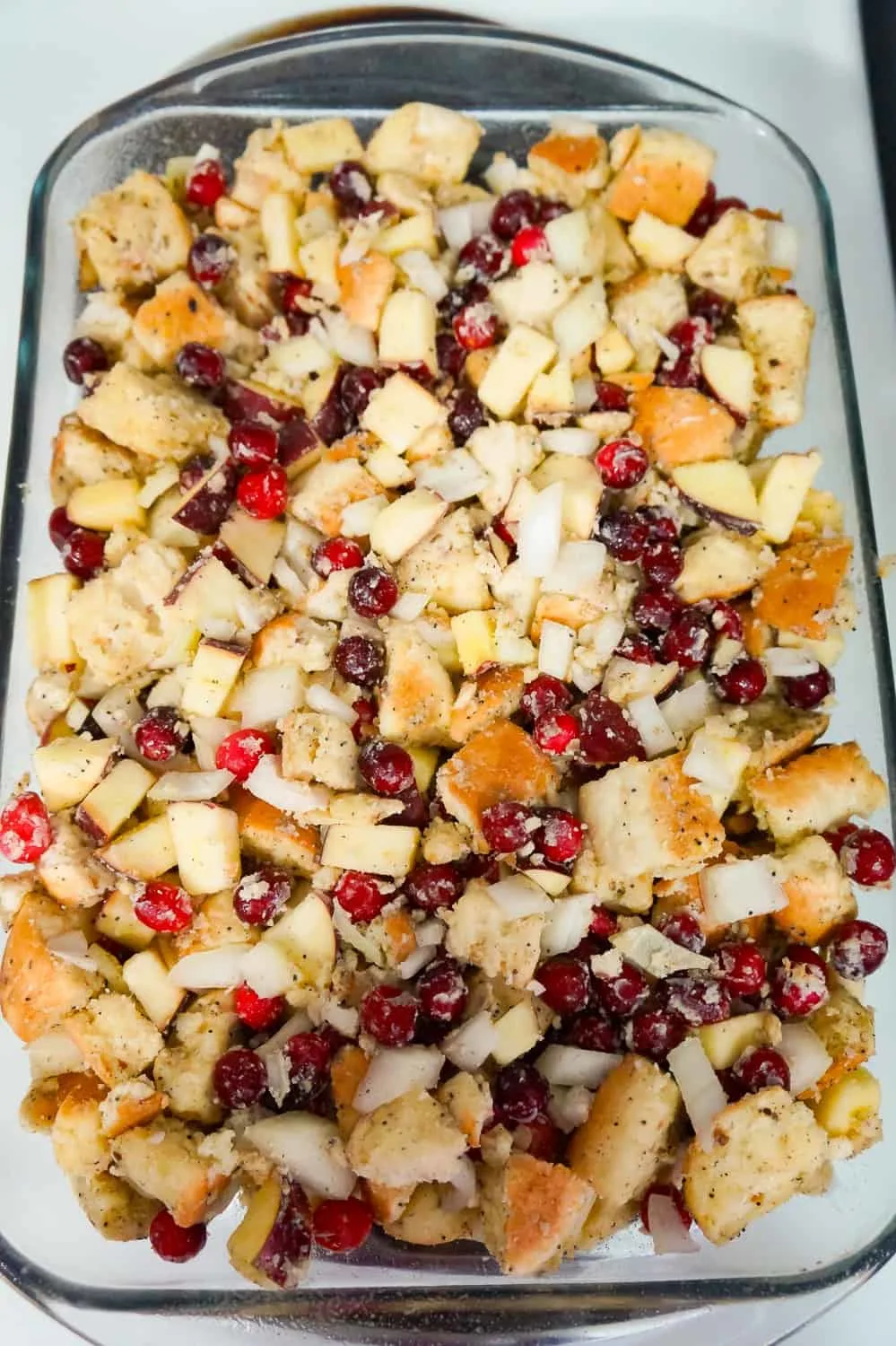 cranberry apple thanksgiving stuffing in baking dish before cooking