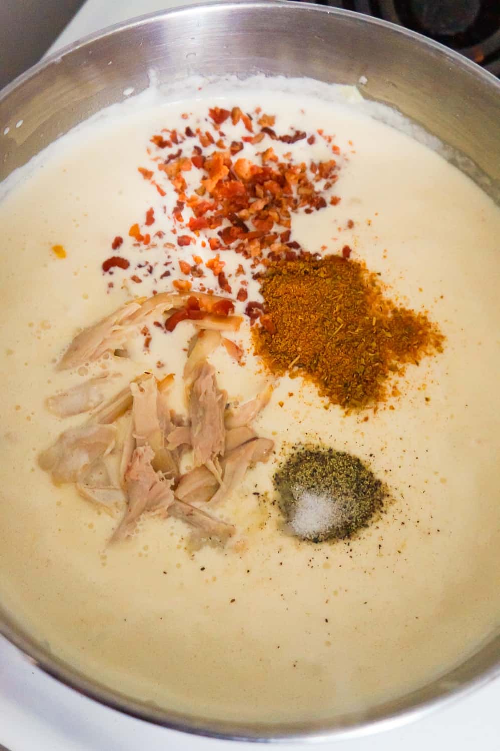 shredded rotisserie chicken, cajun spice, bacon bits, salt and pepper added to a creamy liquid