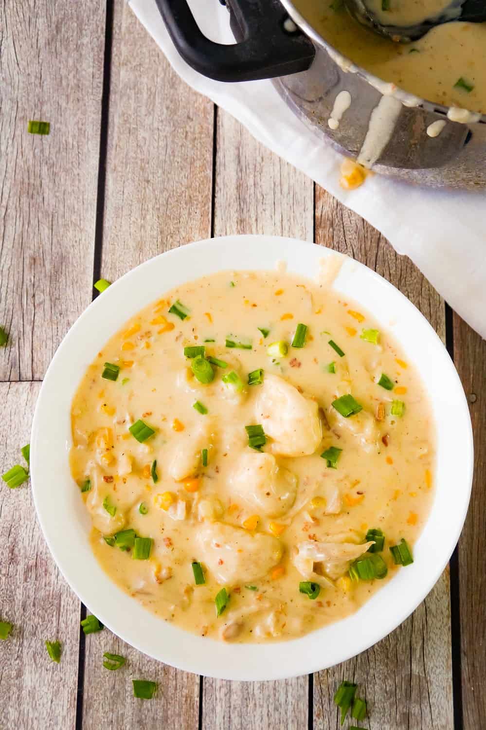Cajun Chicken and Dumplings with Bacon are an easy chicken dinner recipe using Pillsbury refrigerated biscuits. This thick and creamy dish is loaded with rotisserie chicken, corn, real bacon bits and seasoned with Clubhouse Cajun spice for a bit of a kick.