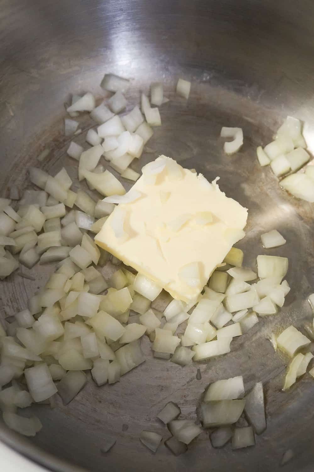 butter melting in a large pot with diced onions