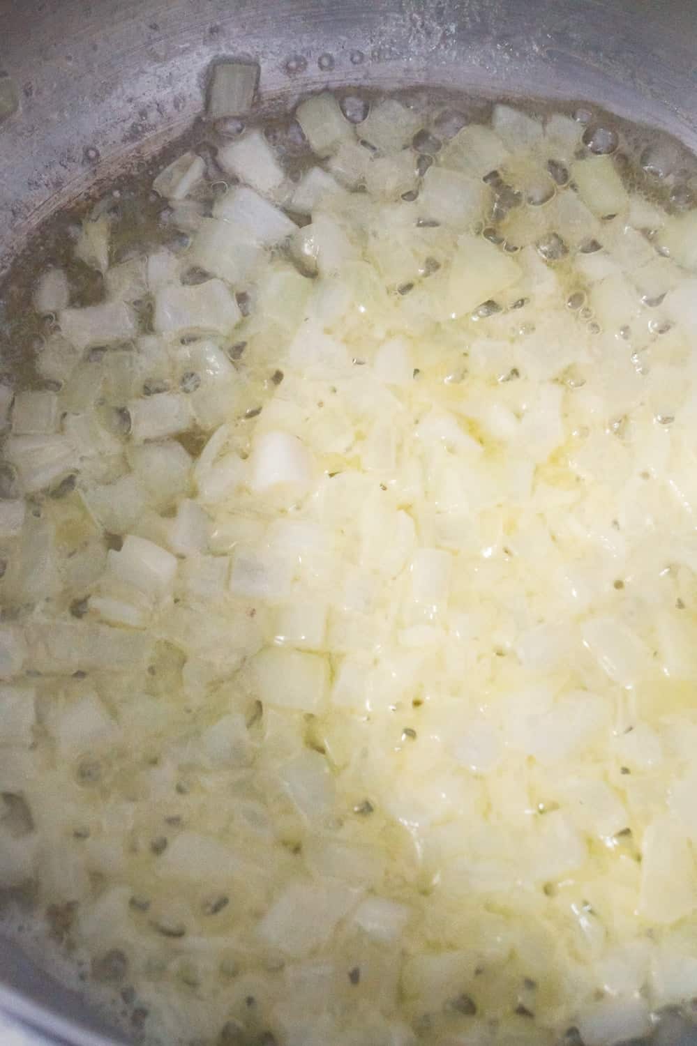 diced onions cooking in a large pot