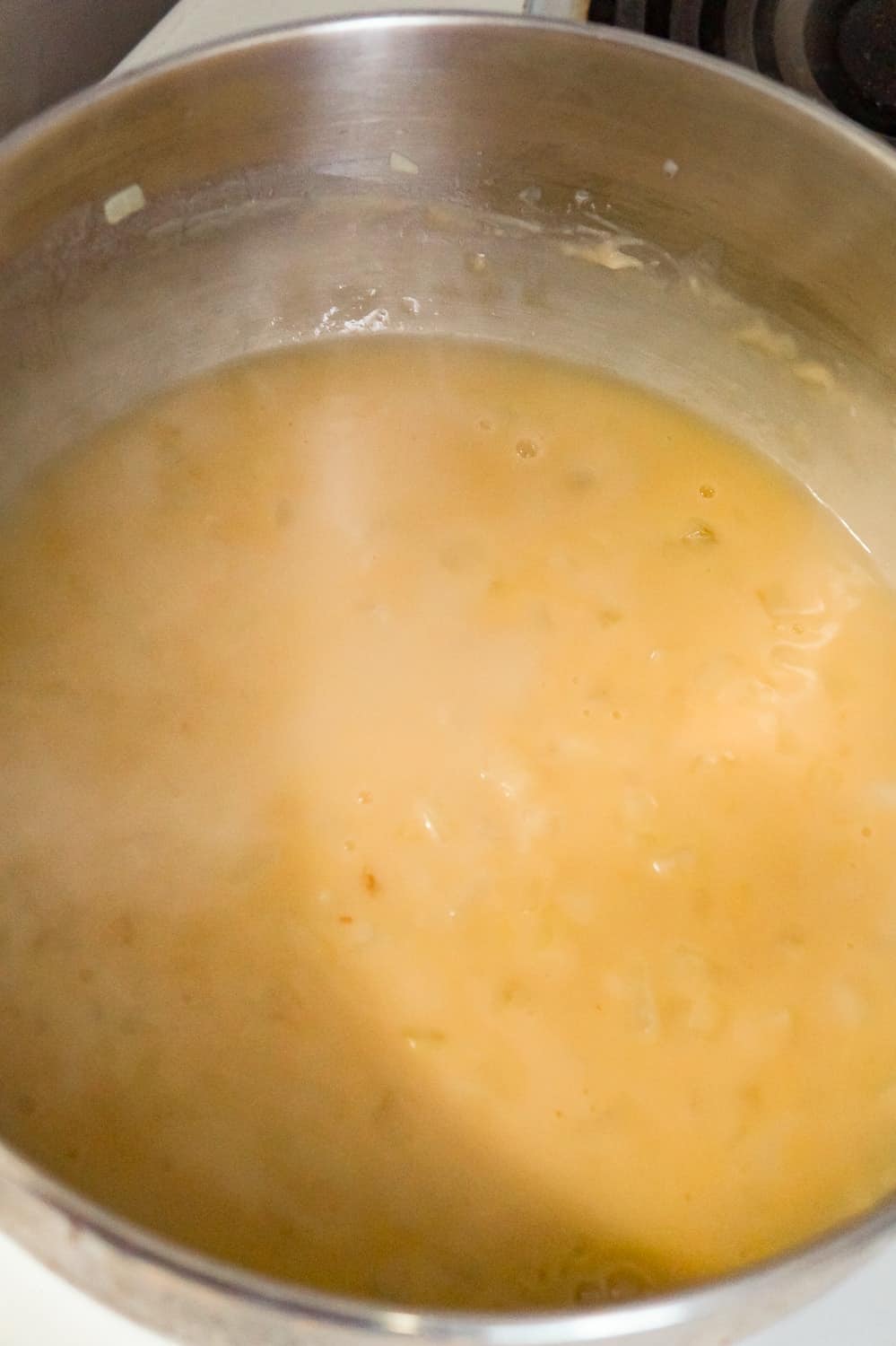 chicken broth added to flour and onion mixture in a large pot