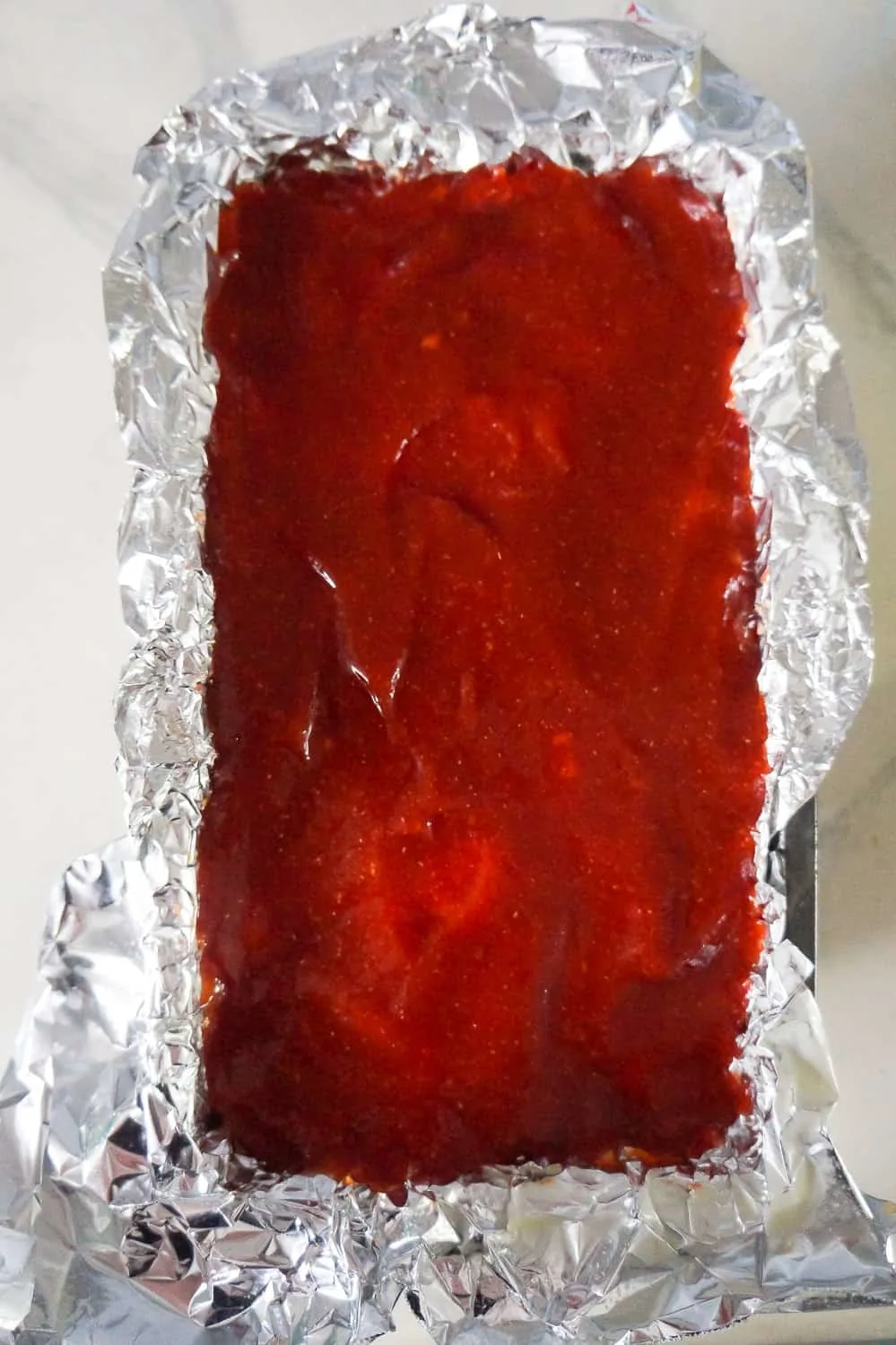 meatloaf with ketchup and brown sugar sauce before baking