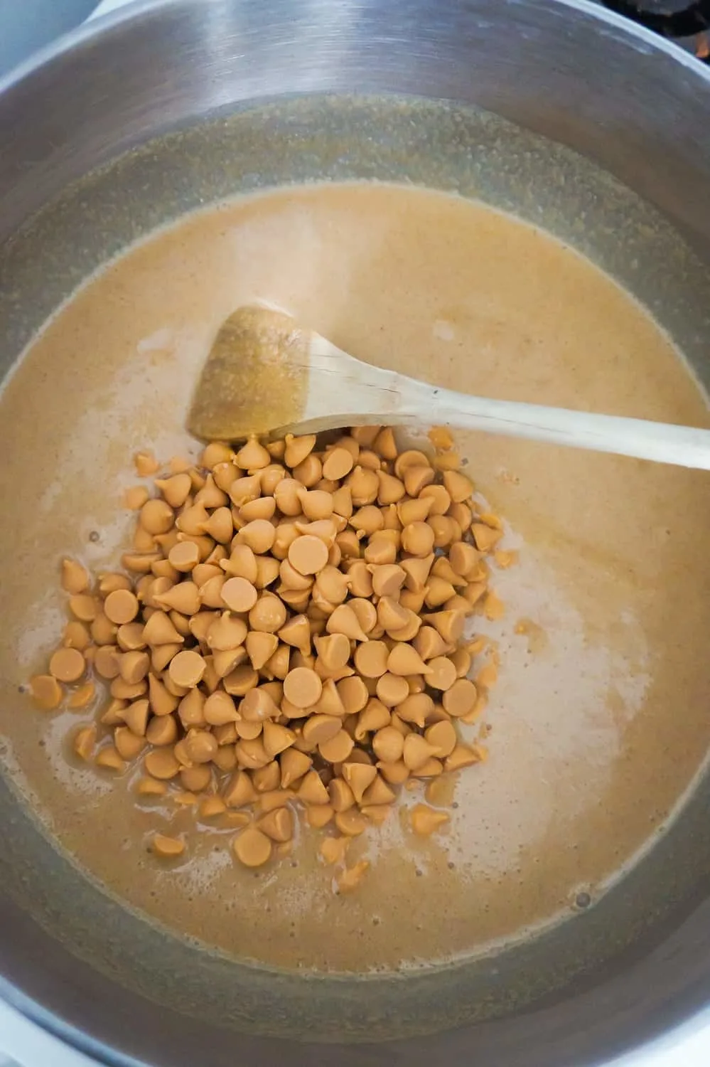 butterscotch chips on top of melted peanut butter in a large saucepan