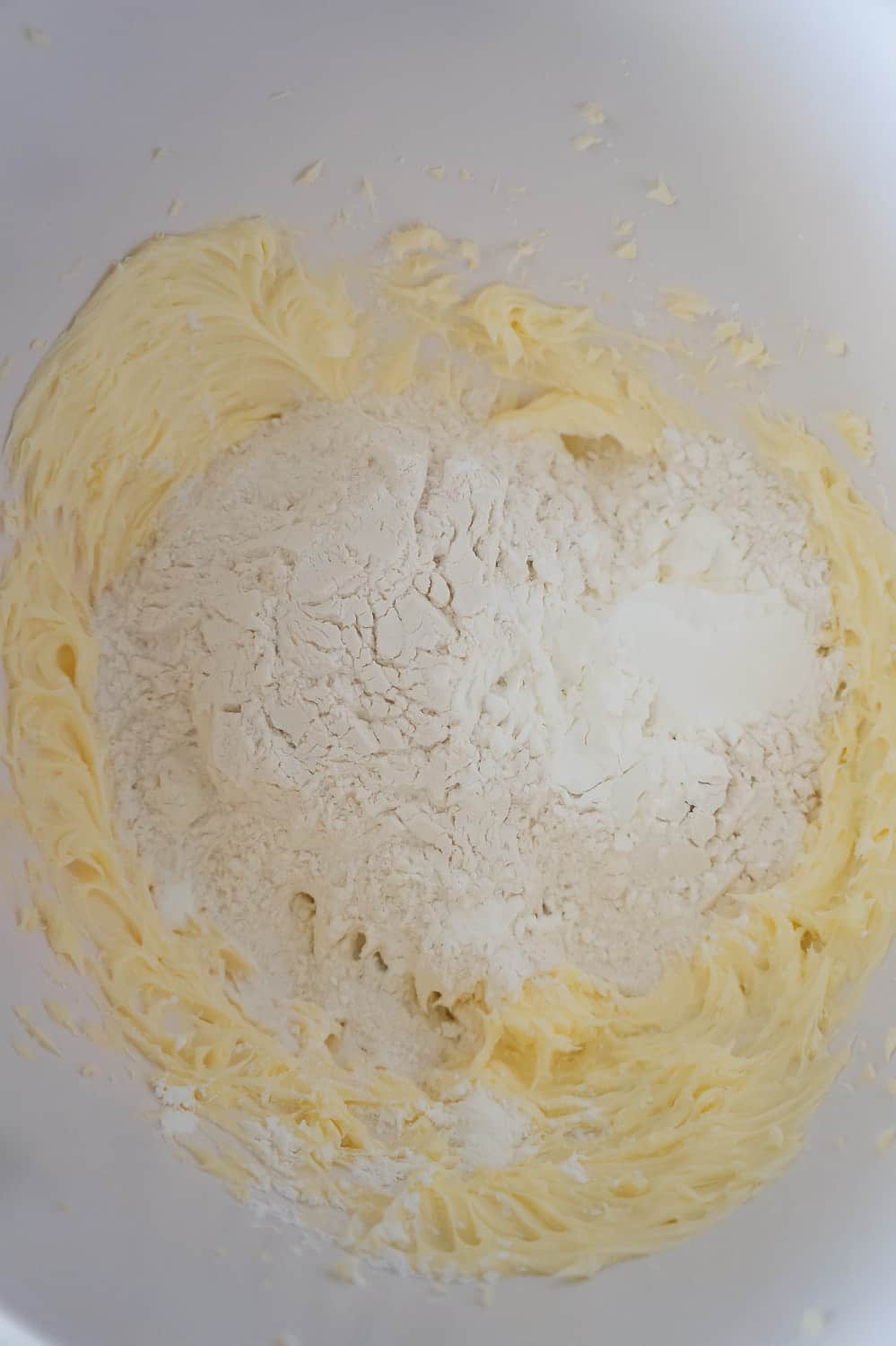 flour and corn starch on top of whipped butter mixture