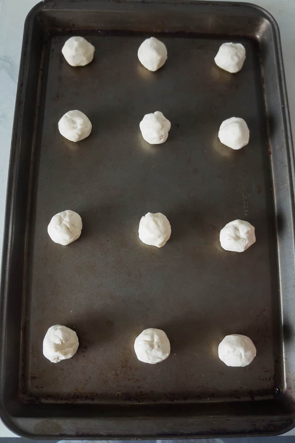 whipped shortbread cookie dough balls on a baking sheet