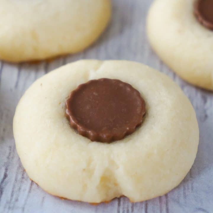 Whipped Shortbread with Peanut Butter Cups is an easy cookie recipe perfect for the holidays. These classic whipped shortbread cookies topped with Reese's Minis are sure to please the peanut butter lovers in your life.