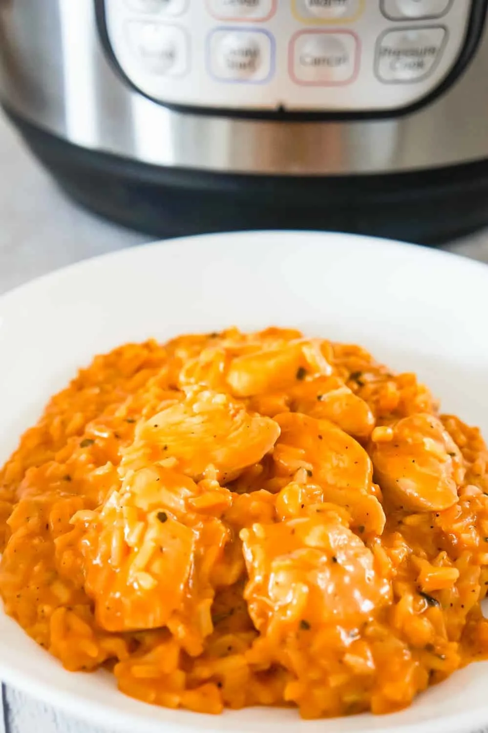 Instant Pot Tomato Basil Chicken and Rice is an easy and delicious pressure cooker recipe. This creamy chicken and rice dish is made with tomato soup and basil pesto.