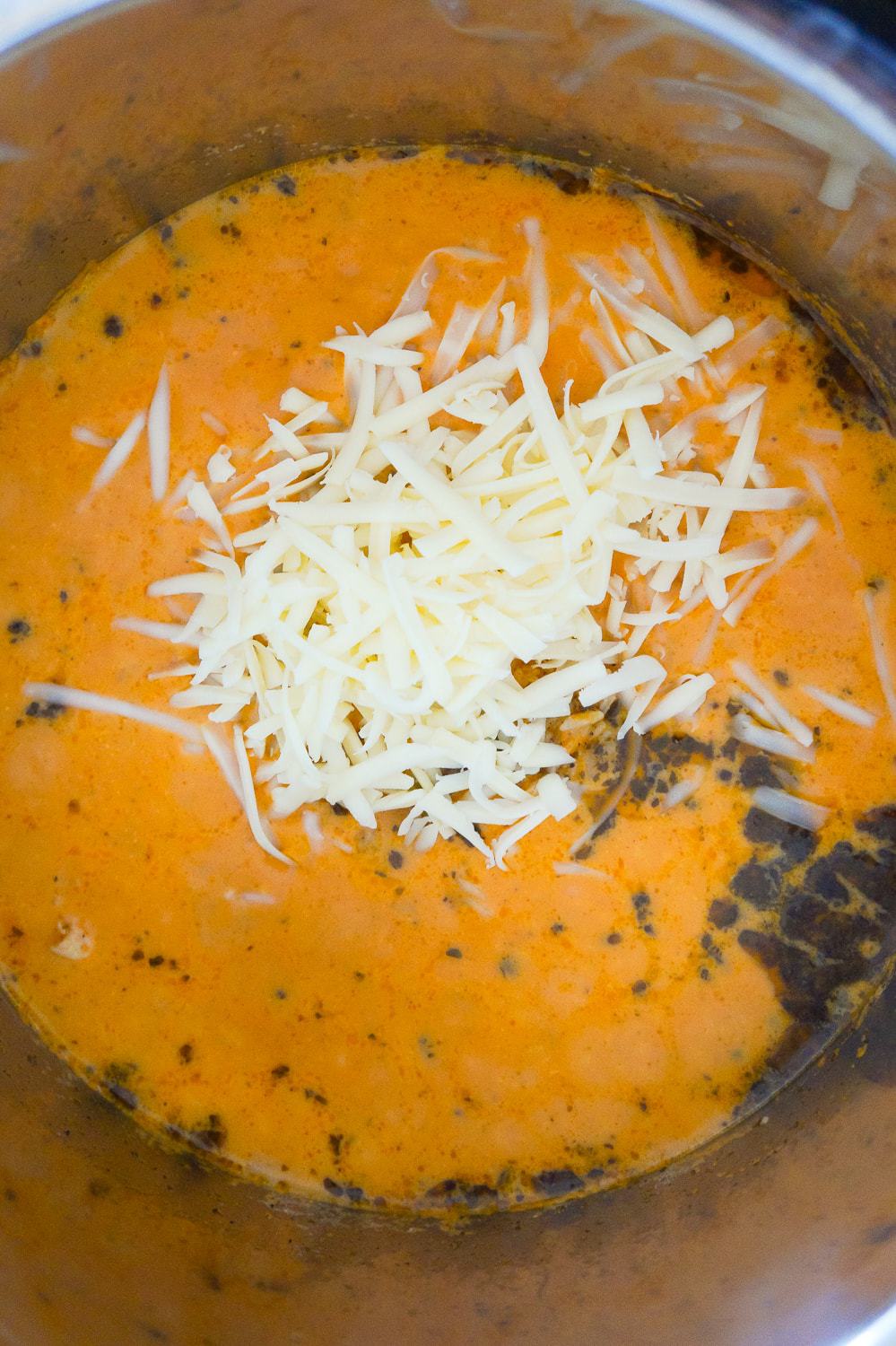 Instant Pot Tomato Basil Chicken and Rice is an easy and delicious pressure cooker recipe. This creamy chicken and rice dish is made with tomato soup and basil pesto.