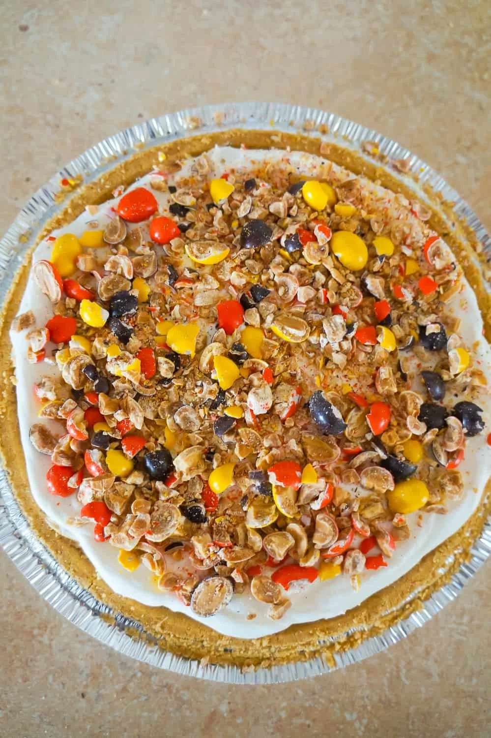 peanut butter pie with crushed Reese's Pieces on top