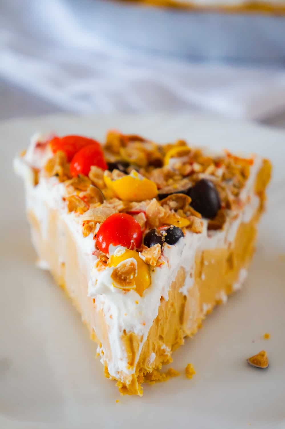 Peanut Butter Pie is an easy no bake dessert for peanut butter lovers. This no bake pie has a rich and creamy peanut butter filling, in a store bought graham crust and is topped with Cool Whip and Reese's Pieces Peanut candies.