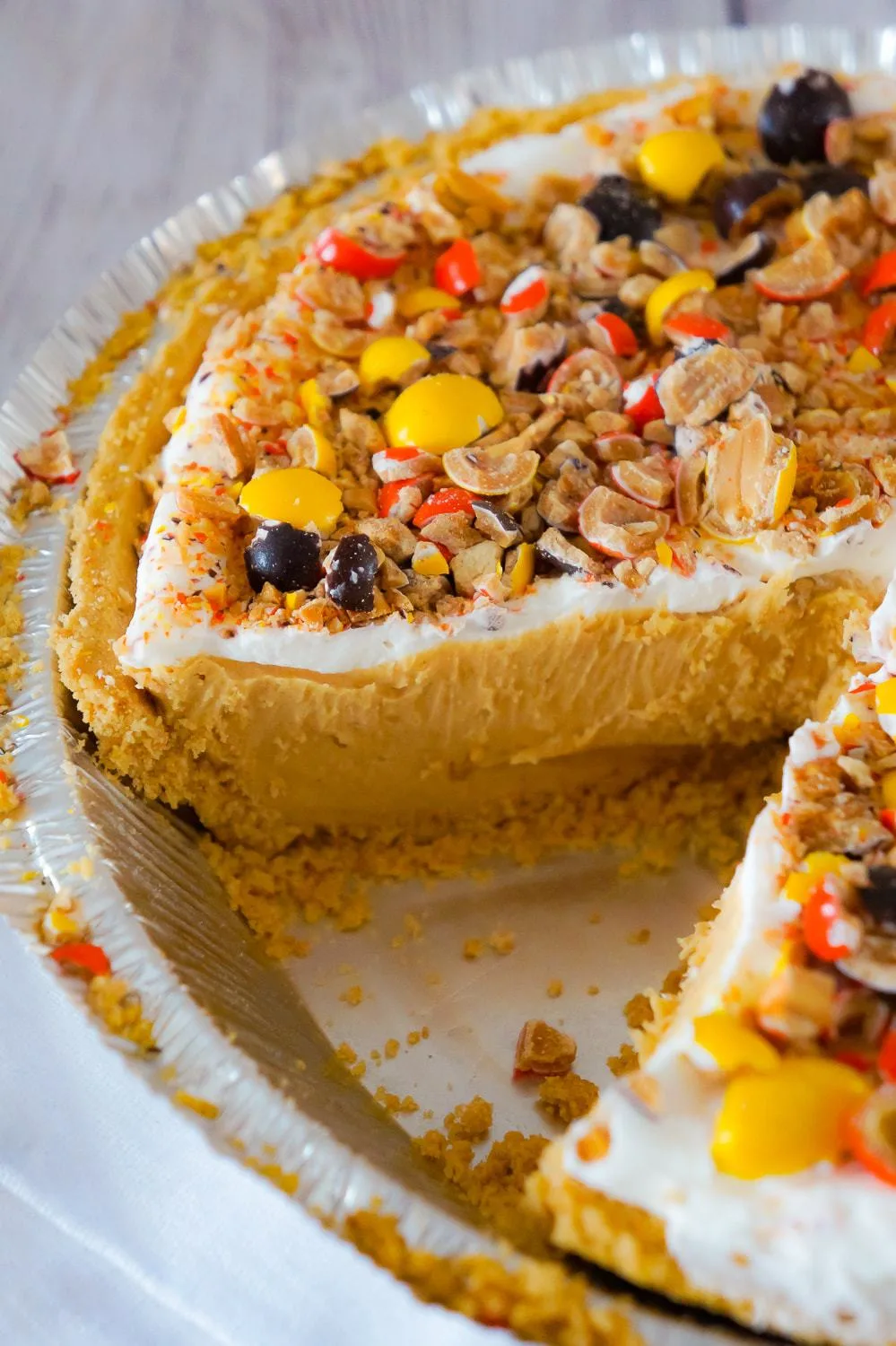 Peanut Butter Pie is an easy no bake dessert for peanut butter lovers. This no bake pie has a rich and creamy peanut butter filling, in a store bought graham crust and is topped with Cool Whip and Reese's Pieces Peanut candies.