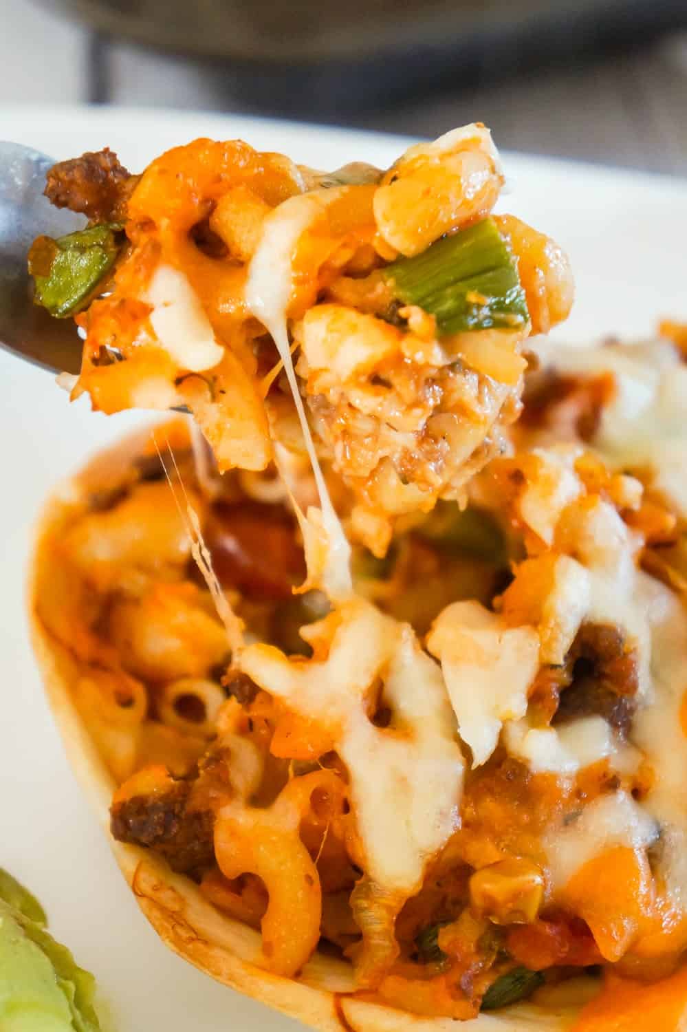 Taco Pasta is an easy ground beef dinner recipe that is fun and kid friendly. This cheesy macaroni tossed in salsa and taco sauce is baked in Old El Paso Tortilla Bowls.