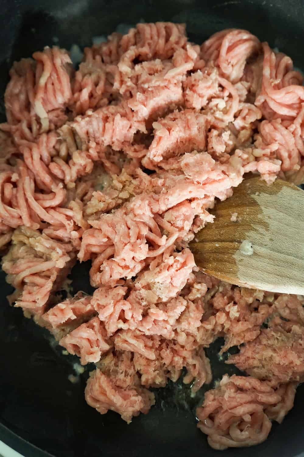 raw ground turkey in a frying pan