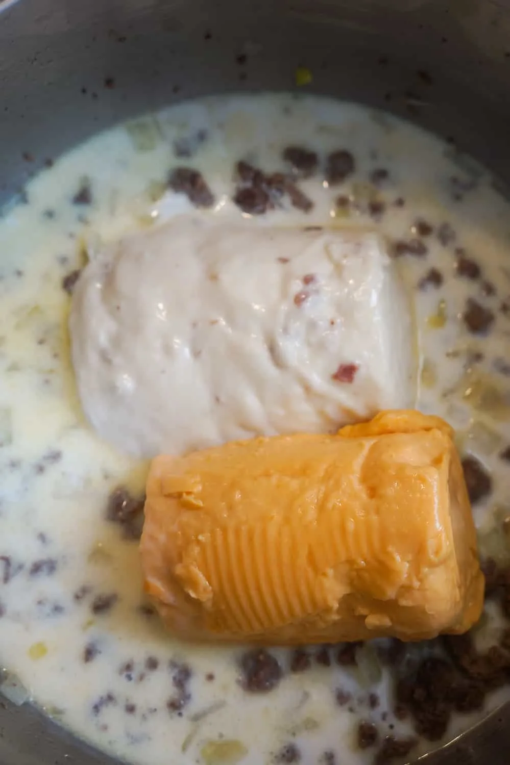 condensed cream of bacon soup and condensed cheddar cheese soup added to pot with milk and ground beef