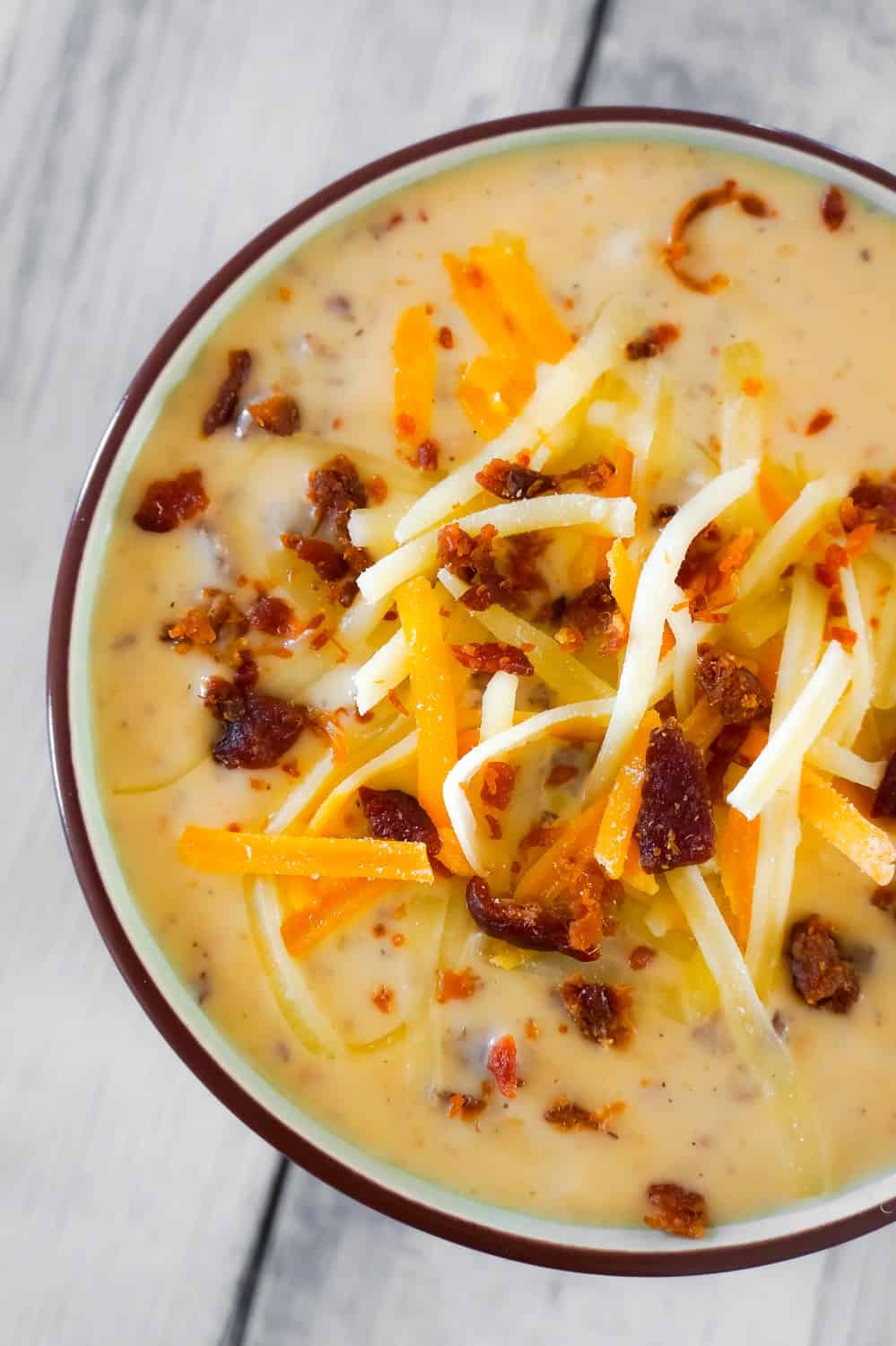 Bacon Cheeseburger Soup is a hearty soup recipe that can be whipped up in just fifteen minutes. This tasty dish made with Campbell's Cream of Bacon soup and Campbell's Cheddar Cheese soup, is loaded with ground beef, real bacon bits and cheddar cheese.