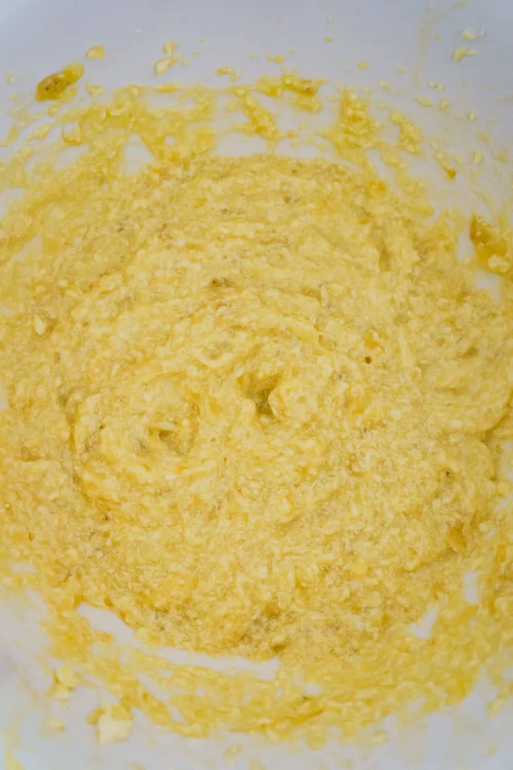 banana, egg and butter mixture in a mixing bowl