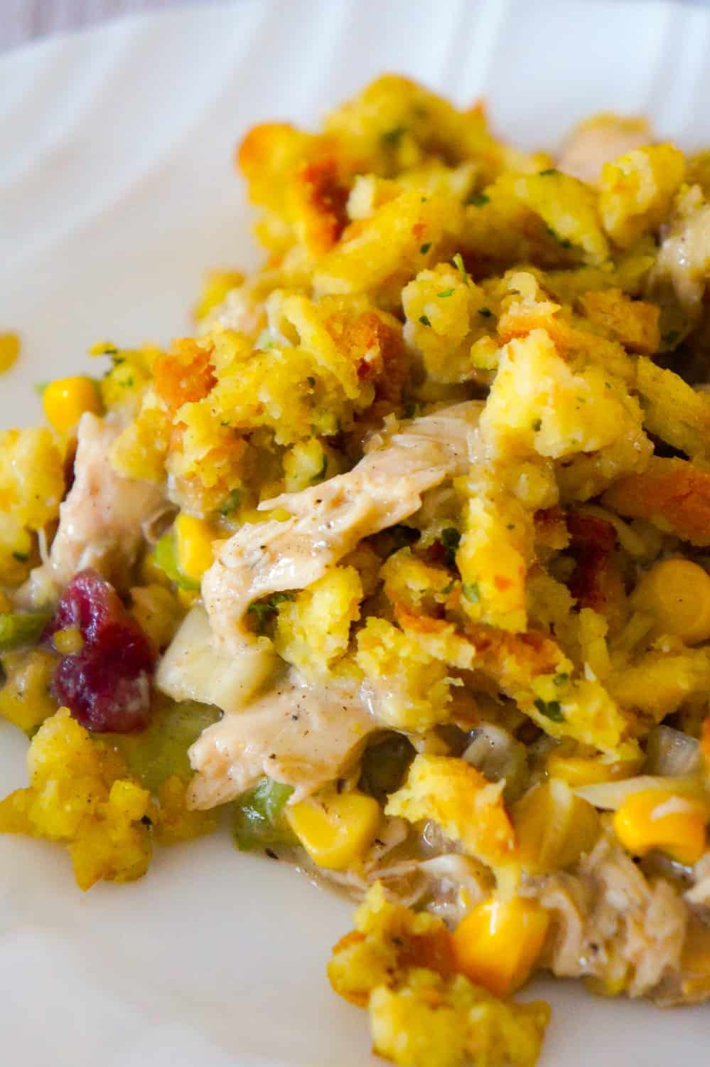 Chicken Casserole with Stuffing is an easy chicken dinner recipe perfect for weeknights. This hearty chicken casserole is loaded with shredded rotisserie chicken, corn, green onions and cranberry sauce and topped with stove top stuffing.