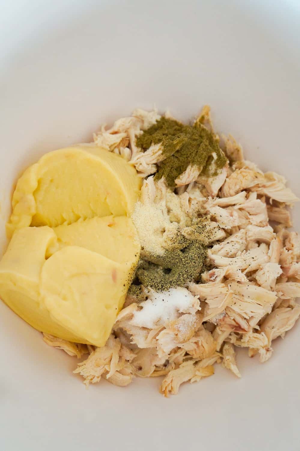 shredded chicken, salt, pepper, ground sage and cream of chicken soup in a mixing bowl