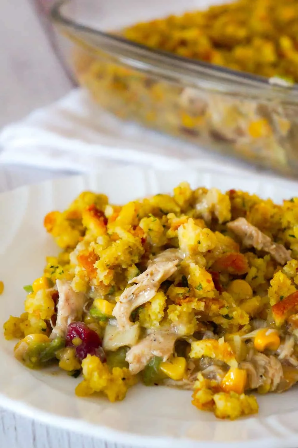 Chicken Casserole with Stuffing is an easy chicken dinner recipe perfect for weeknights. This hearty chicken casserole is loaded with shredded rotisserie chicken, corn, green onions and cranberry sauce and topped with stove top stuffing.