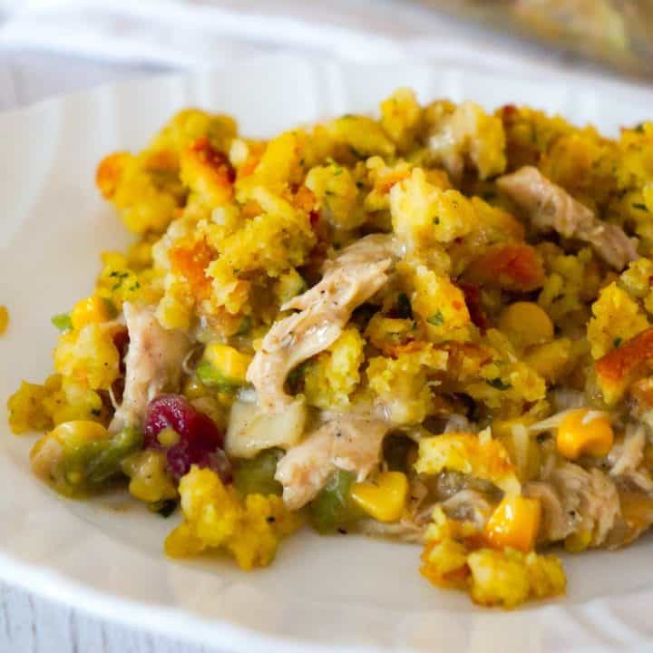 Chicken Casserole with Stuffing is an easy chicken dinner recipe perfect for weeknights. This hearty chicken casserole is loaded with shredded rotisserie chicken, corn, green onions and cranberry sauce and topped with stove top stuffing.