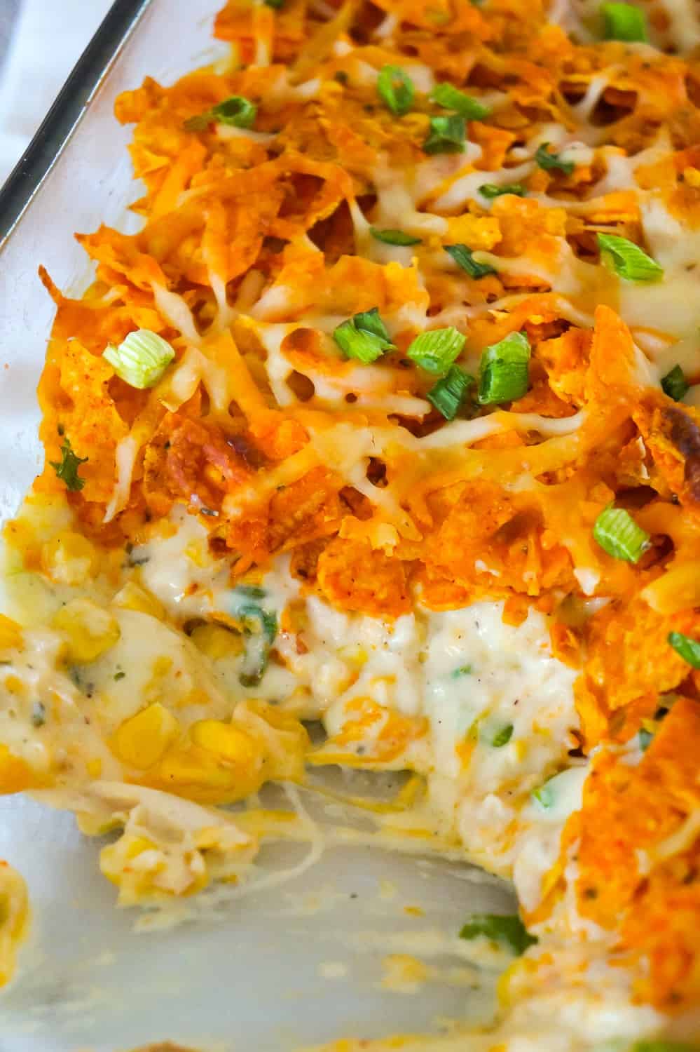 Doritos Casserole with Chicken is an easy weeknight dinner recipe using rotisserie chicken. This creamy chicken casserole is loaded with cream cheese, corn, shredded cheddar and topped with crumbled Doritos.