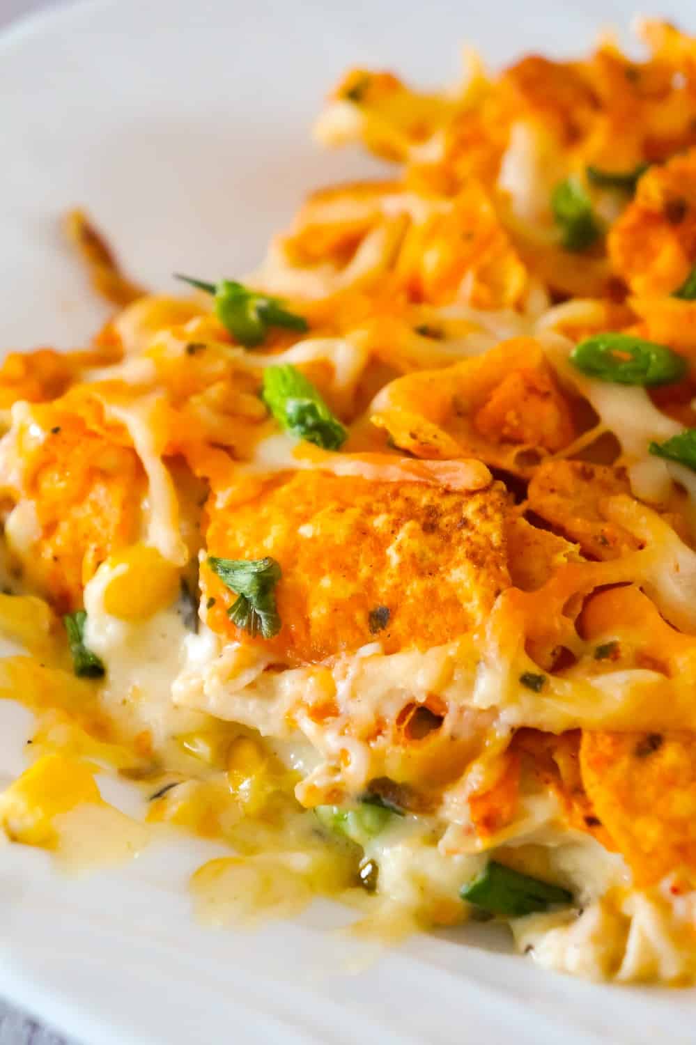 Doritos Casserole with Chicken is an easy weeknight dinner recipe using rotisserie chicken. This creamy chicken casserole is loaded with cream cheese, corn, shredded cheddar and topped with crumbled Doritos.