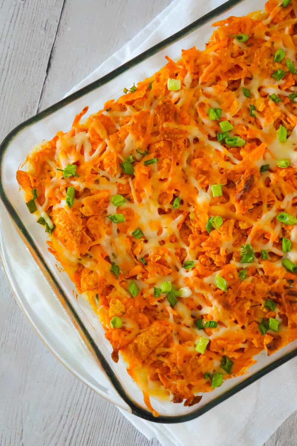 Doritos Casserole with Chicken is an easy weeknight dinner recipe using rotisserie chicken. This creamy chicken casserole is loaded with cream cheese, corn, shredded cheddar and topped with crumbled Doritos.