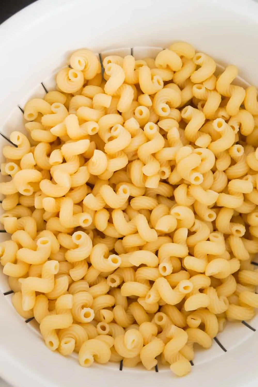 cooked cavatappi noodles in a strainer