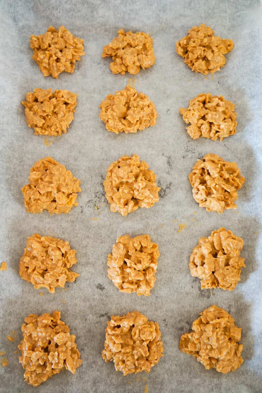 no bake peanut butter cookies on a parchment lined baking sheet