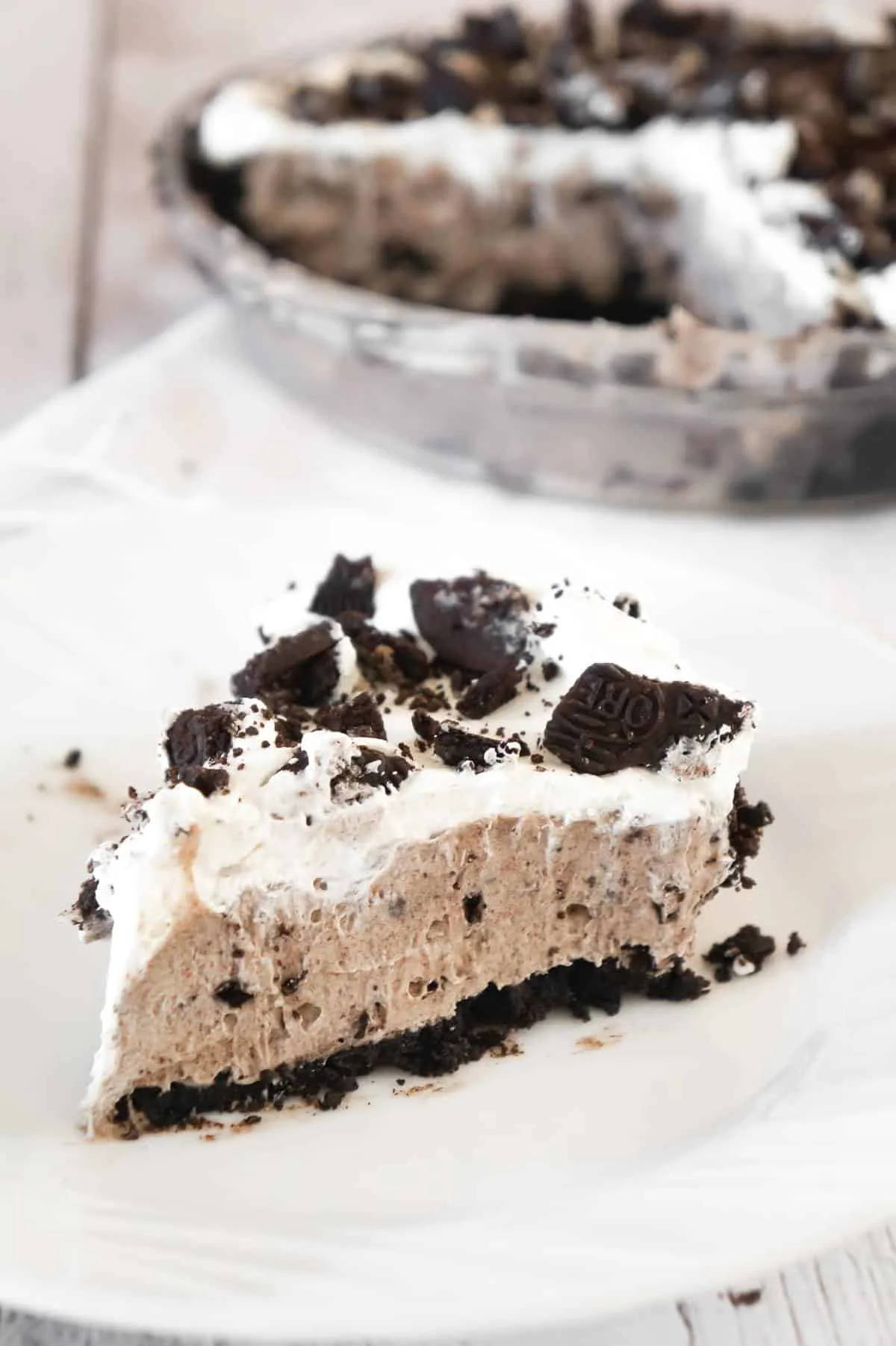 Oreo Pie is a tasty no bake dessert recipe that starts out with an Oreo crumb pie crust, filled with a creamy pudding and crushed Oreo mixture and topped with Cool Whip.