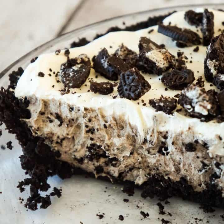 Oreo Pie is an easy no bake dessert recipe using vanilla instant pudding and a store bought Oreo crust. The creamy pudding and Cool Whip filling is loaded with white chocolate and crushed Oreo cookies.