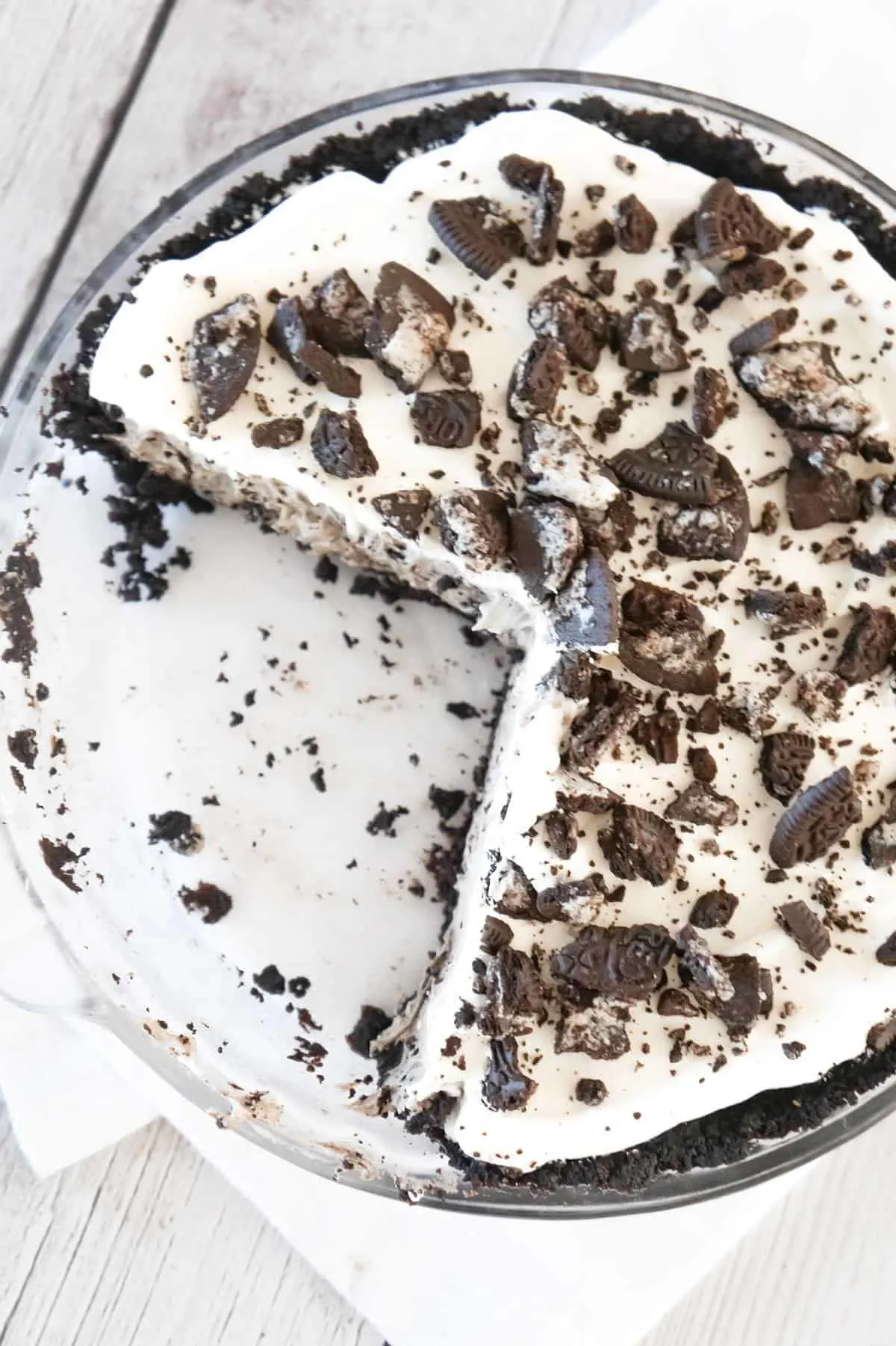 Oreo Pie is a tasty no bake dessert recipe that starts out with an Oreo crumb pie crust, filled with a creamy pudding and crushed Oreo mixture and topped with Cool Whip.