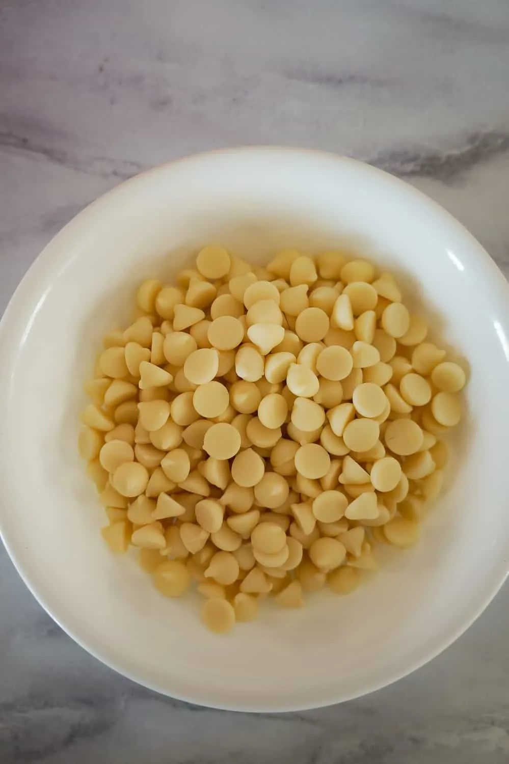 white chocolate chips in a white bowl