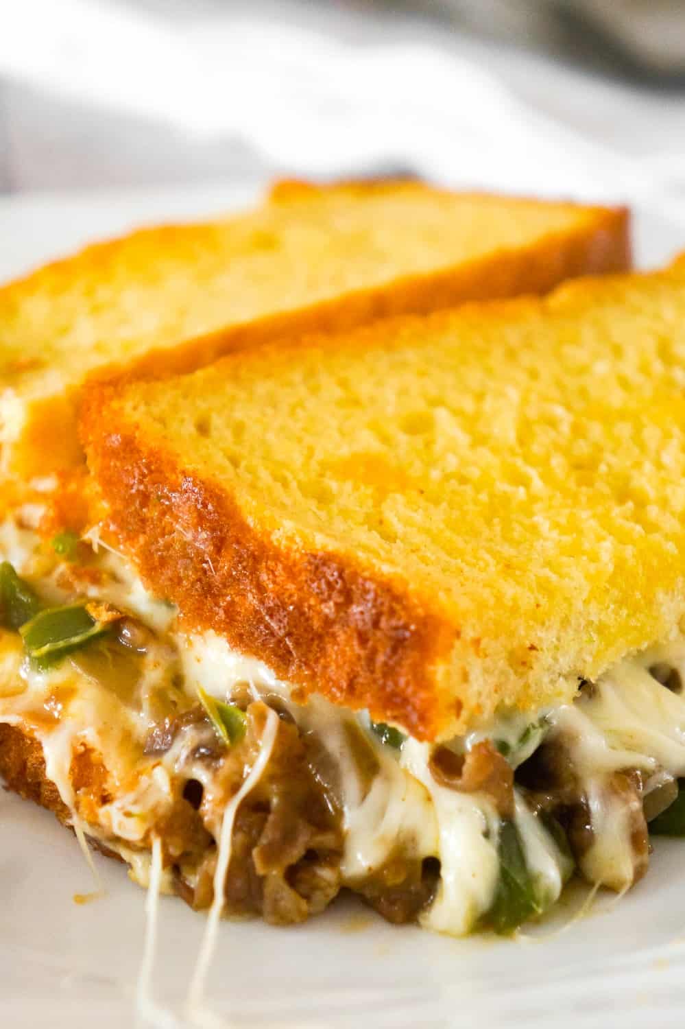 Philly Cheese Steak Grilled Cheese Casserole is a fun twist on a classic sandwich. This simple and delicious casserole is loaded with roast beef, green peppers, onions and oozing with mozzarella cheese.