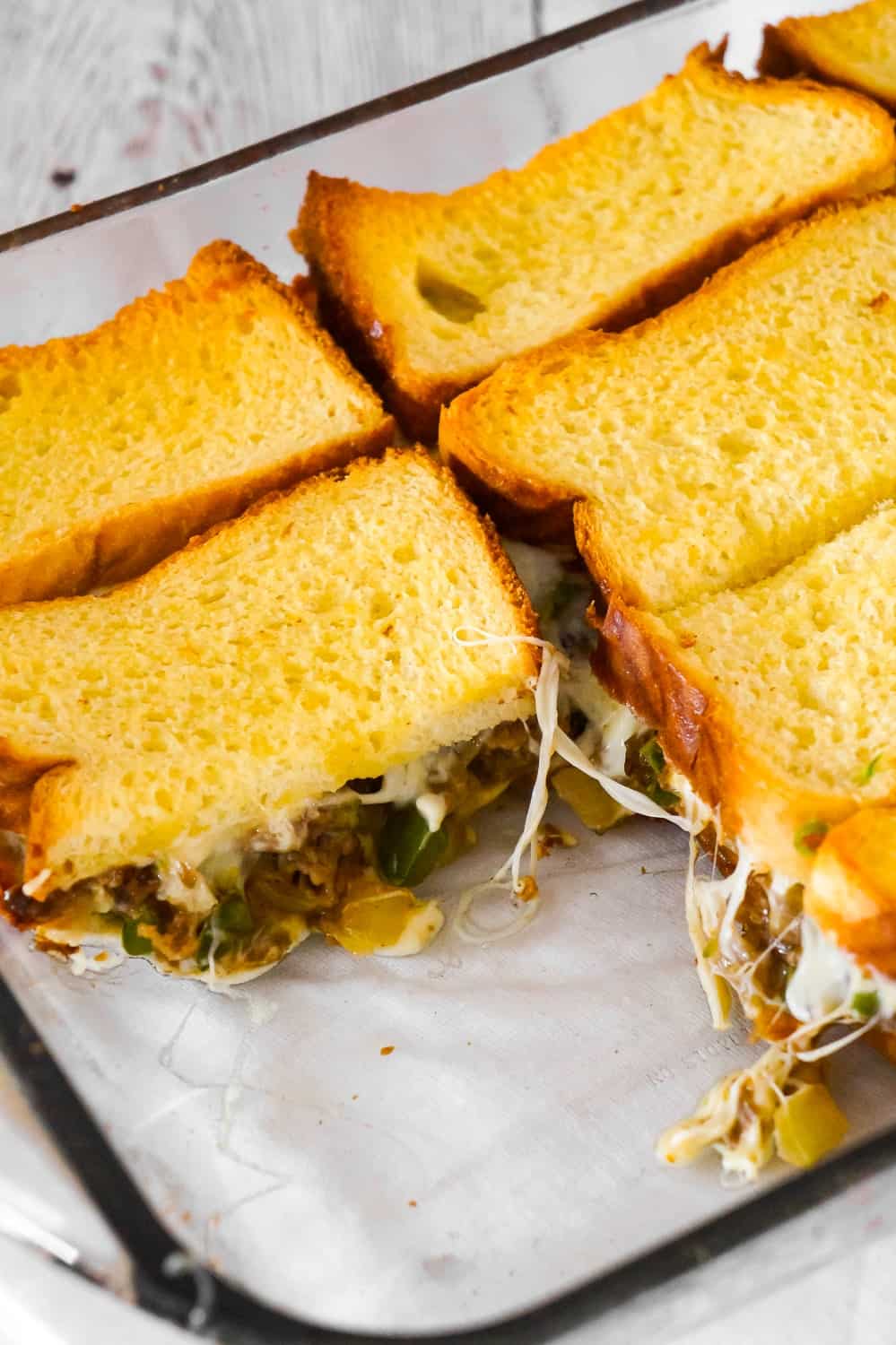 Philly Cheese Steak Grilled Cheese Casserole is a fun twist on a classic sandwich. This simple and delicious casserole is loaded with roast beef, green peppers, onions and oozing with mozzarella cheese.