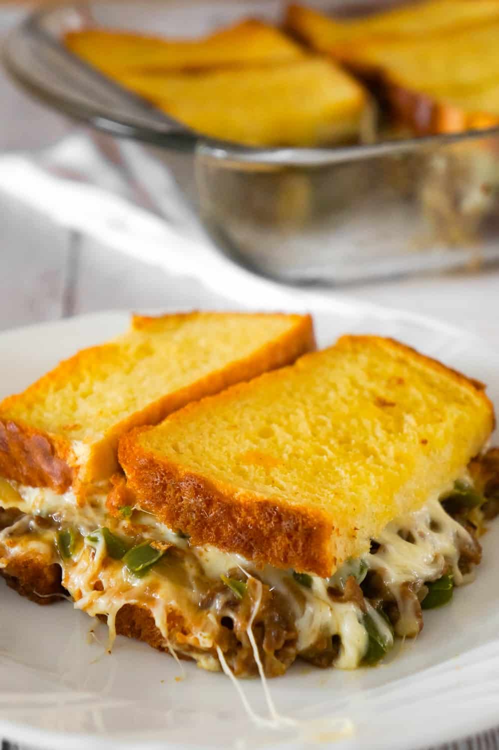 Philly Cheese Steak Grilled Cheese Casserole is a fun twist on a classic sandwich. This simple and delicious casserole is loaded with roast beef, green peppers, onions and oozing with mozzarella cheese.