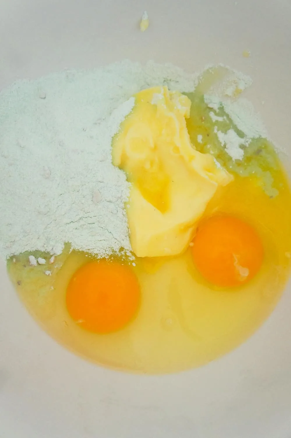 eggs, softened butter and pistachio pudding mix in a mixing bowl