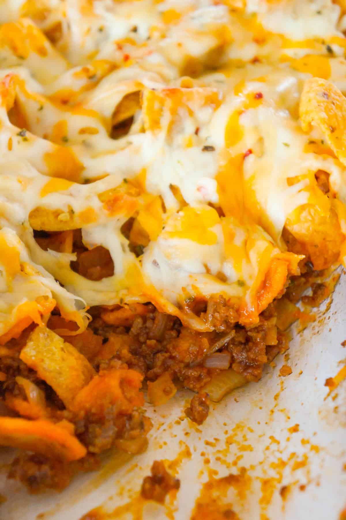 Sloppy Joe Frito Pie is a delicious casserole recipe with ground beef and onions tossed in homemade sloppy joe sauce and topped with Fritos corn chips and shredded cheese.