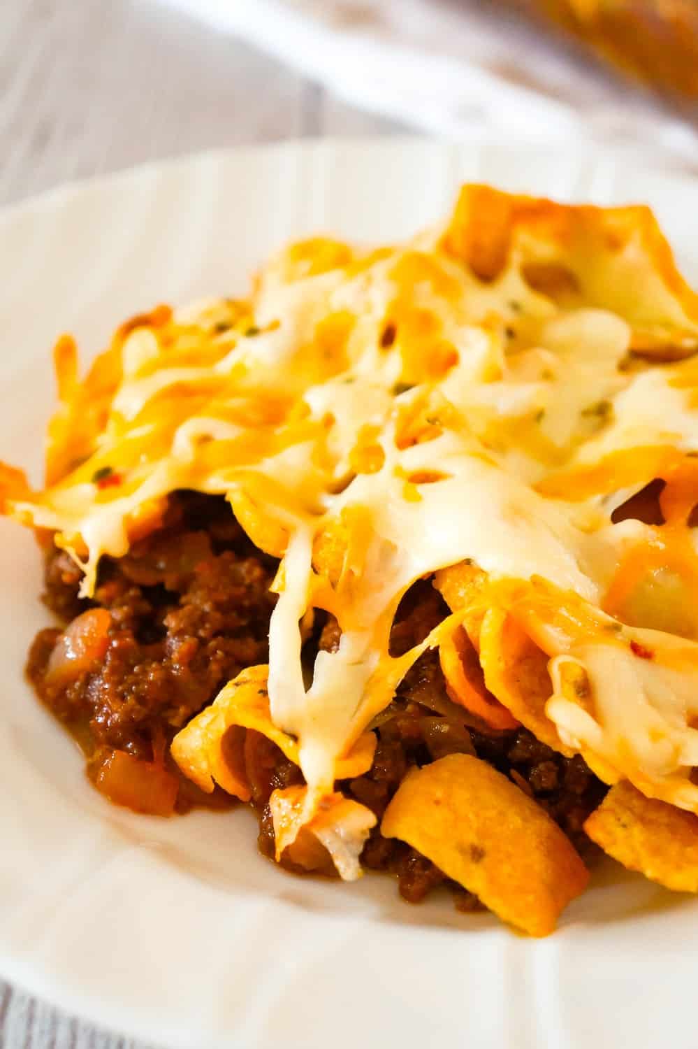 Sloppy Joe Frito Pie is an easy ground beef dinner recipe perfect for weeknights. Ground beef and onions are tossed in homemade sloppy joe sauce and then topped with Frito's corn chips and cheddar cheese.