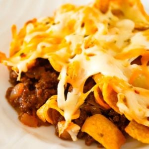 Sloppy Joe Frito Pie is a delicious casserole recipe with ground beef and onions tossed in homemade sloppy joe sauce and topped with Fritos corn chips and shredded cheese.