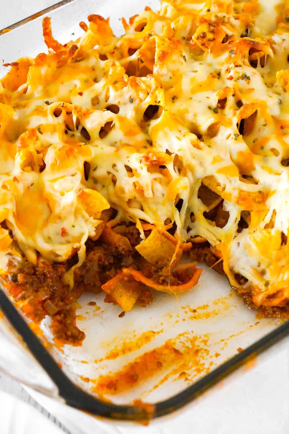 Sloppy Joe Frito Pie is an easy ground beef dinner recipe perfect for weeknights. Ground beef and onions are tossed in homemade sloppy joe sauce and then topped with Frito's corn chips and cheddar cheese.