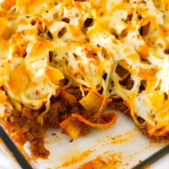 Sloppy Joe Frito Pie is an easy ground beef dinner recipe perfect for weeknights. Ground beef and onions are tossed in homemade sloppy joe sauce and then topped with Frito's corn chips and cheddar cheese.