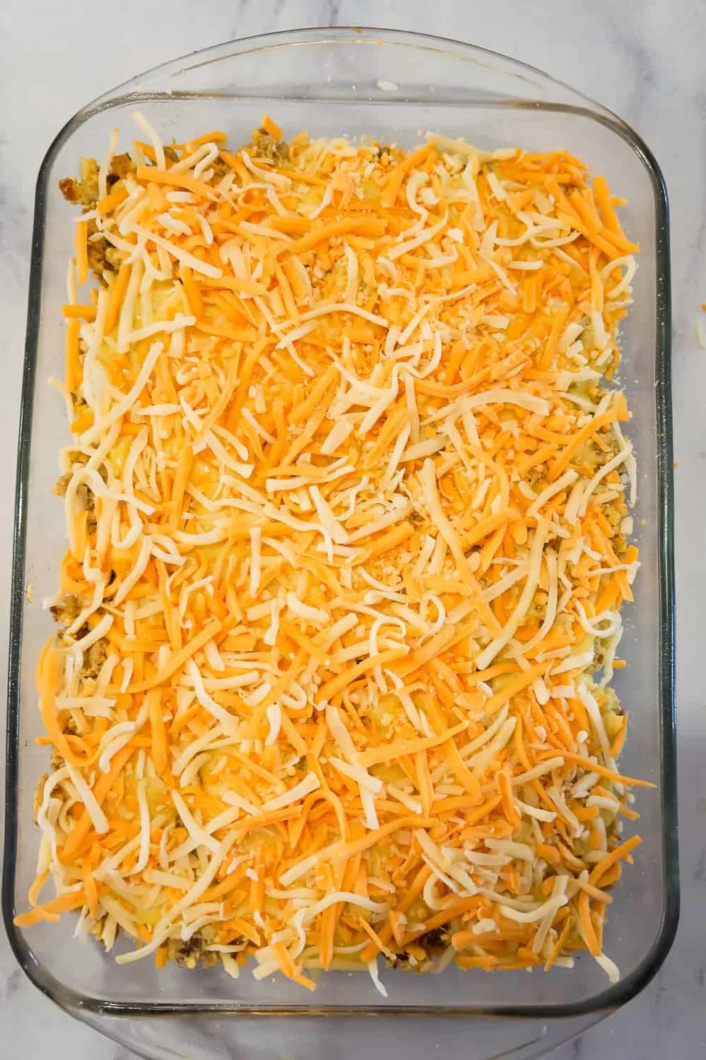 shredded mozzarella and cheddar on top of breakfast casserole