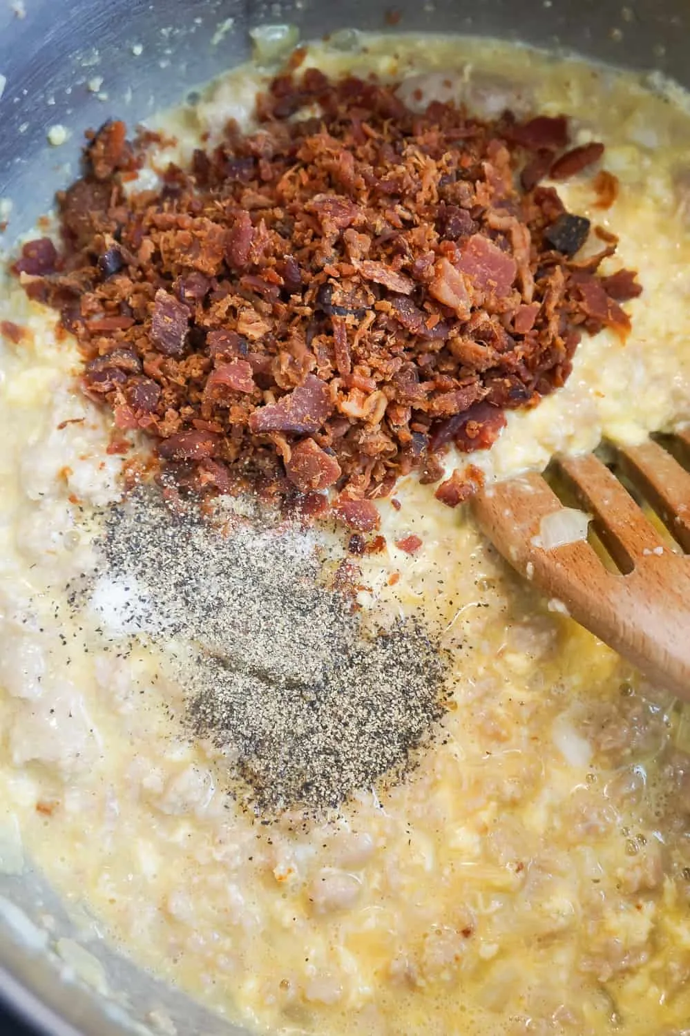 bacon bits, salt and pepper added to egg mixture in a saucepan