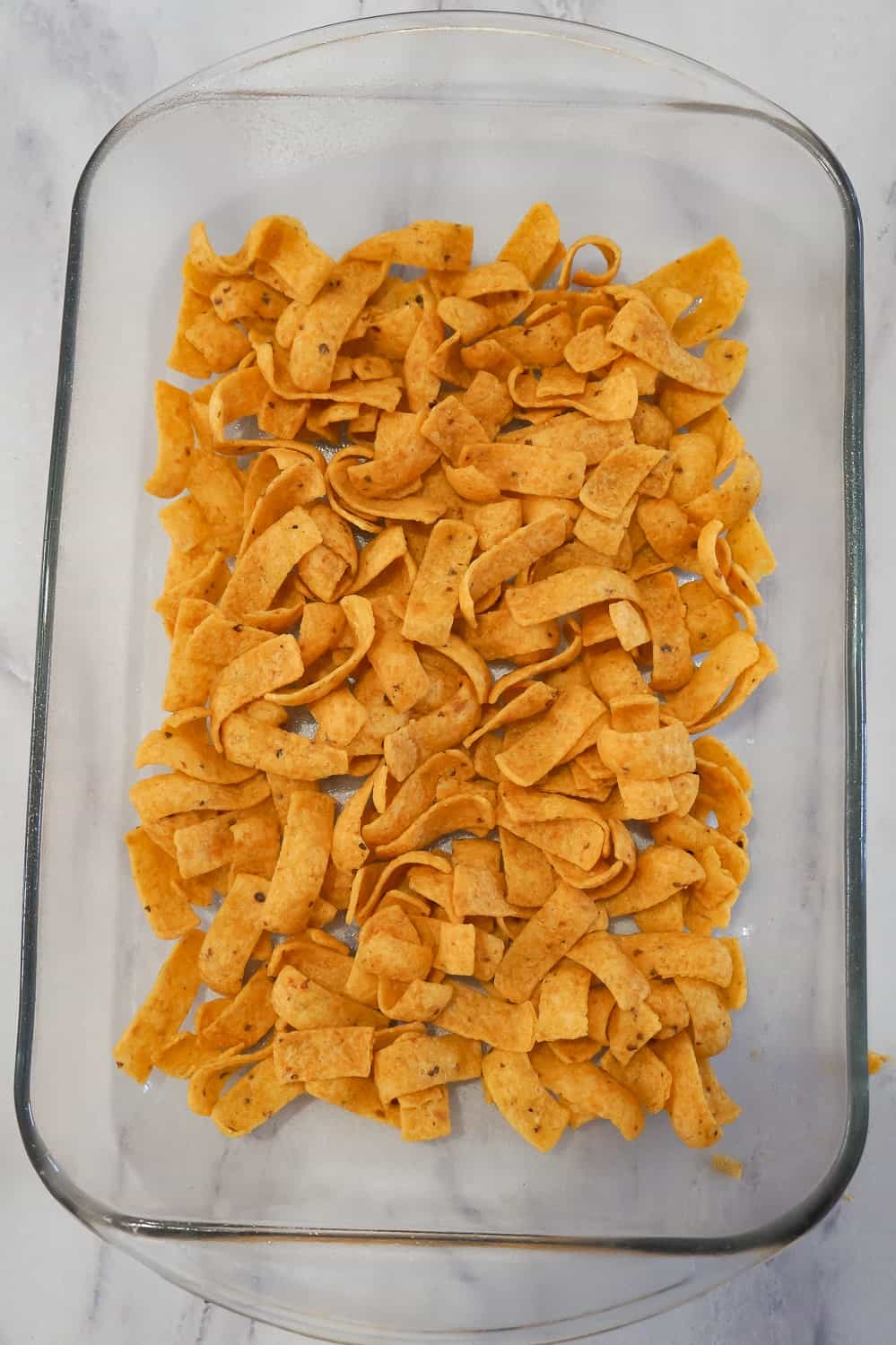 Frito's corn chips in the bottom of a baking dish