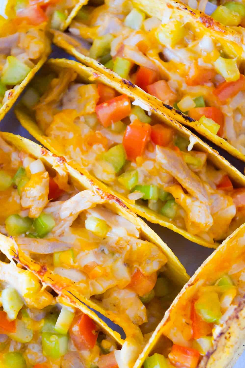 Buffalo Chicken Tacos are an easy dinner recipe using rotisserie chicken. These baked chicken tacos are loaded with buffalo sauce, ranch dressing, celery, tomatoes, onions and cheddar cheese.