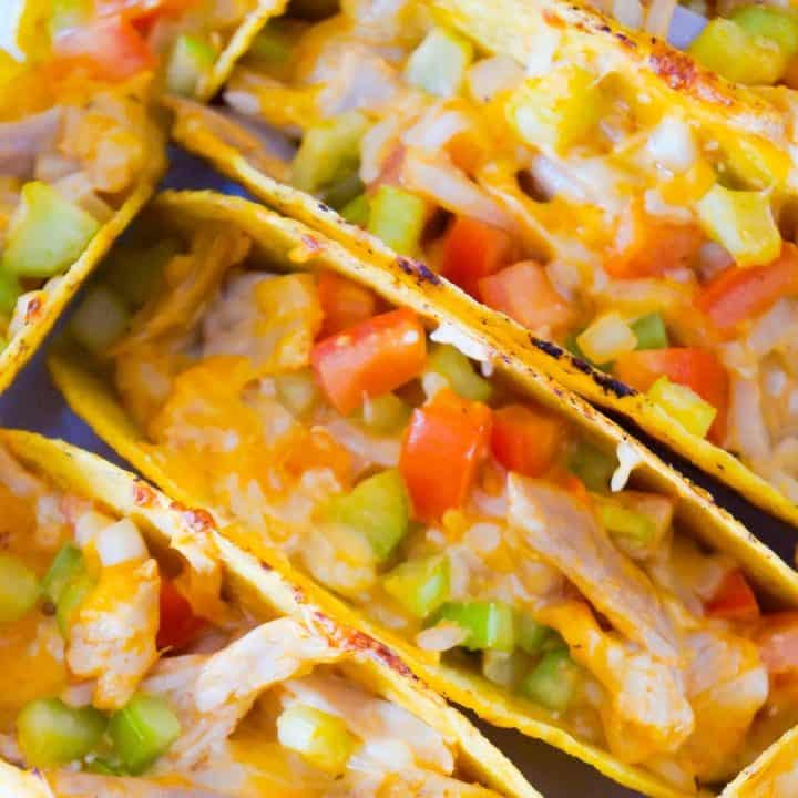 Buffalo Chicken Tacos are an easy dinner recipe using rotisserie chicken. These baked chicken tacos are loaded with buffalo sauce, ranch dressing, celery, tomatoes, onions and cheddar cheese.