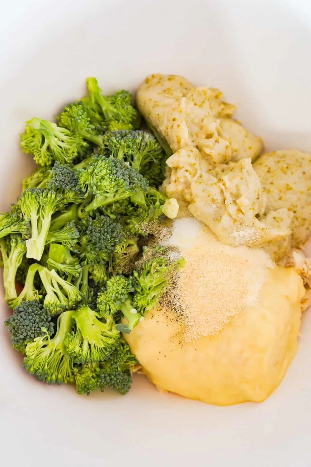 broccoli florets, cream of broccoli soup and cream of chicken soup in a mixing bowl
